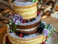 naked cake with fruit and flowers
