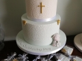 Two tier Christening cake with lace, cross and elephant details.